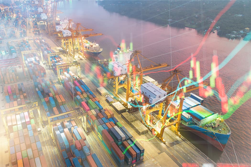 Ship at a port with piles of cargo.