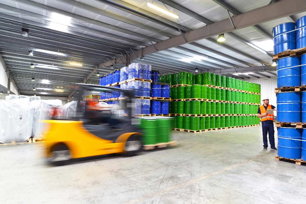Man loading LTL chemical shipment with forklift