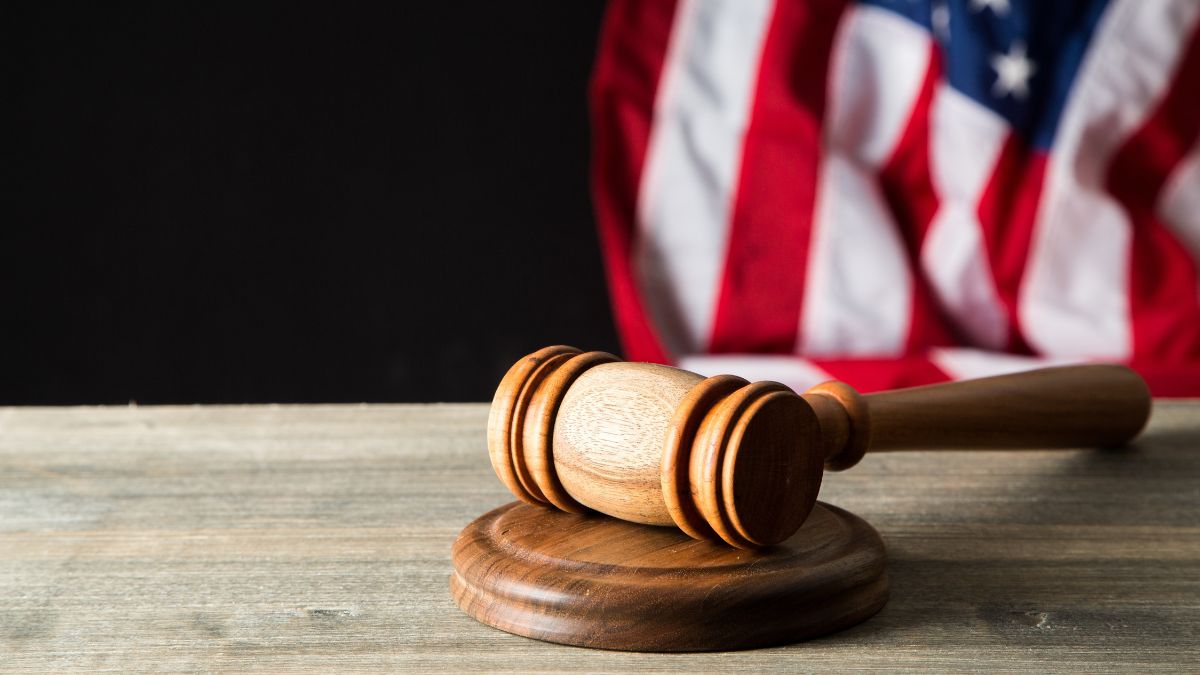 Judges mallet on a table with cropped American flag behind