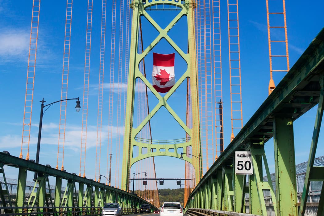 Canadian flag flying on a bridge tower a U.S.–Canada border crossing.